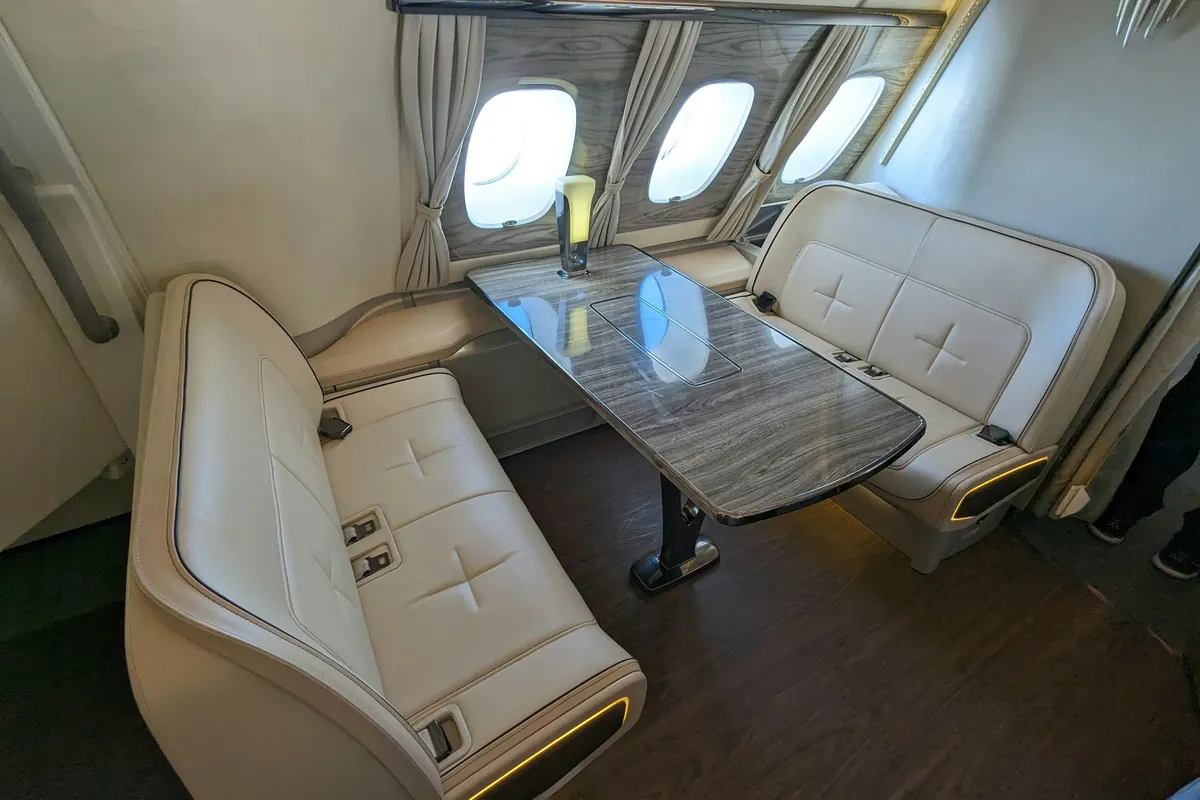 Club seats around a table in a private jet cabin